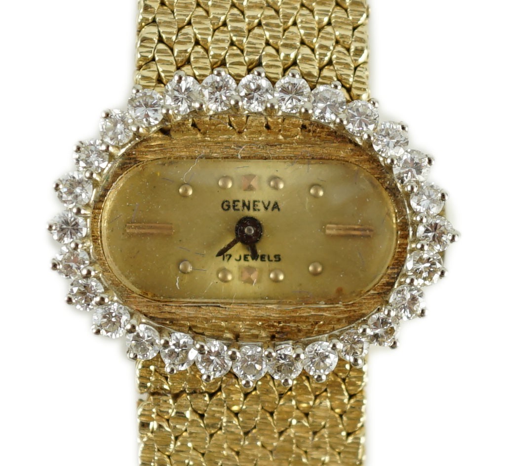 A lady's modern Swiss 14k gold and diamond set manual wind oval wrist watch, on integral 14k gold bracelet